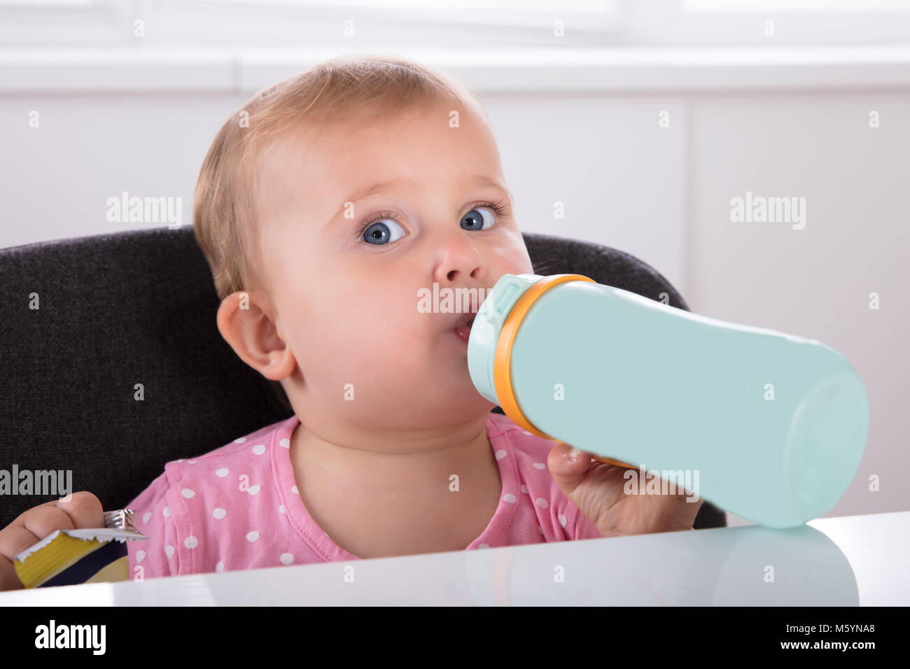 Close-up Of A Cute Little Baby Girl Drinking Water From Bottle Stock Photo