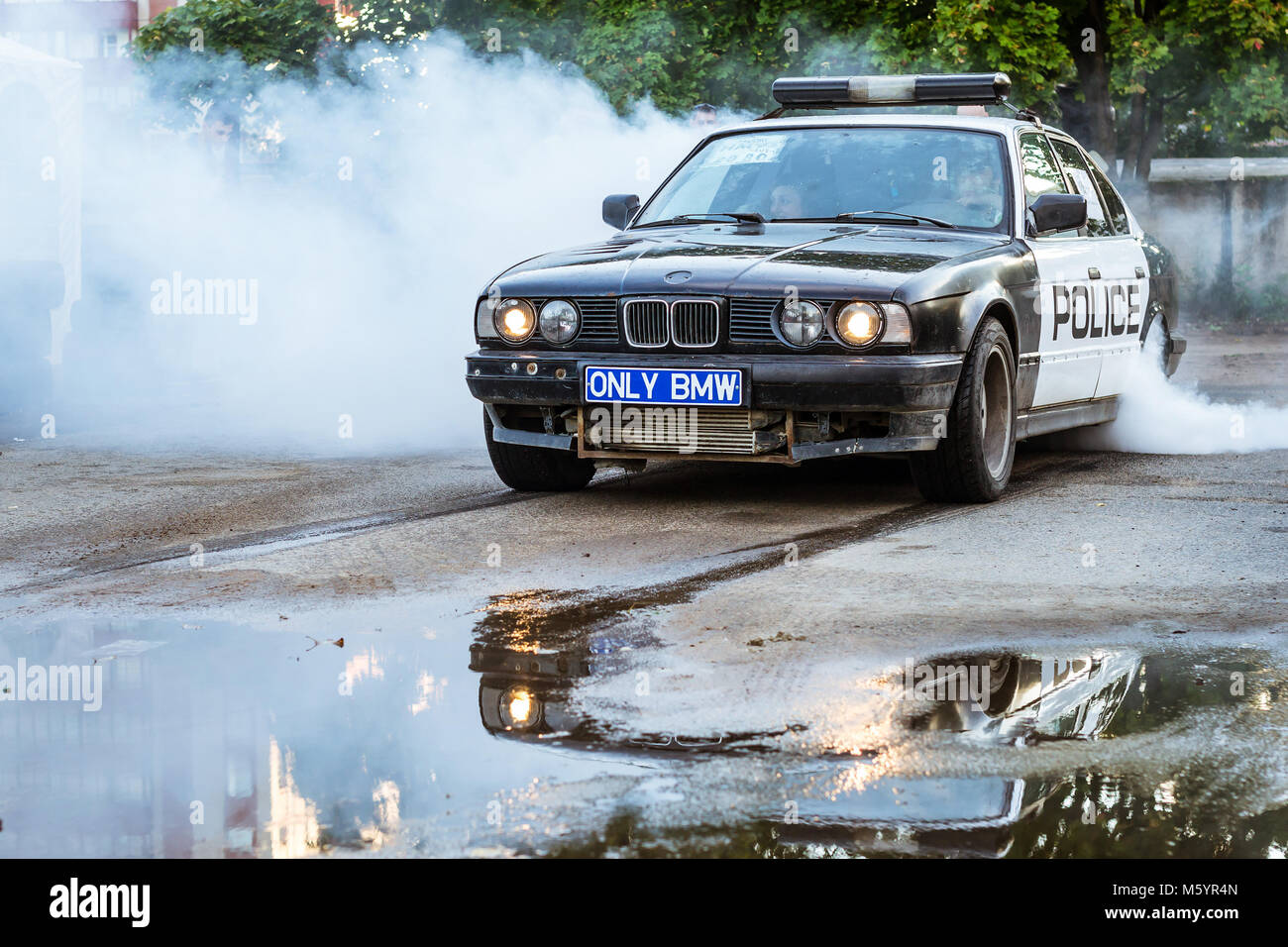 St-Petersburg, Russia - September 16, 2017: Police car BMW 5-series on drift racing motorsport. German Bavarian BMW driftcar burning tires on asphalt  Stock Photo
