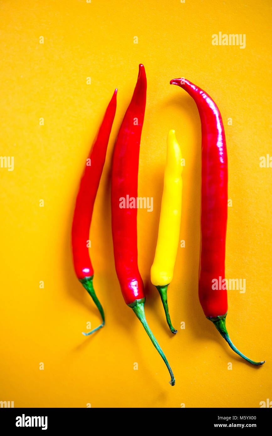 Above view at Chili pepper on yellow background Stock Photo - Alamy