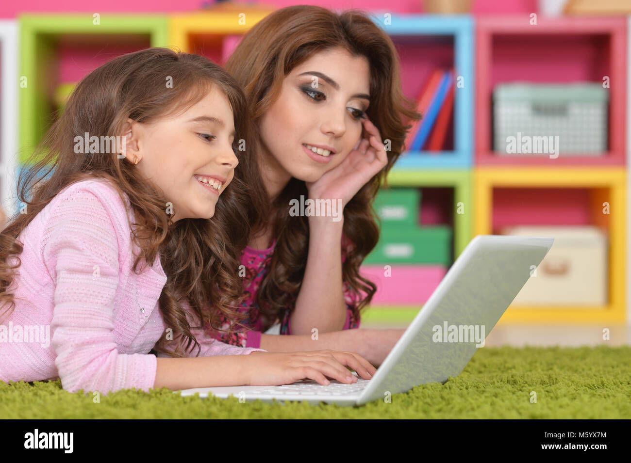 woman and little girl using laptop Stock Photo - Alamy