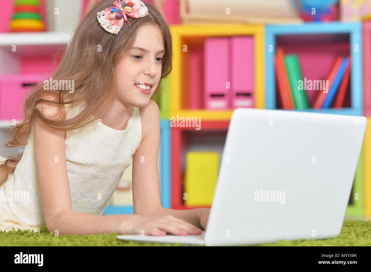 Cute little girl with modern laptop Stock Photo - Alamy