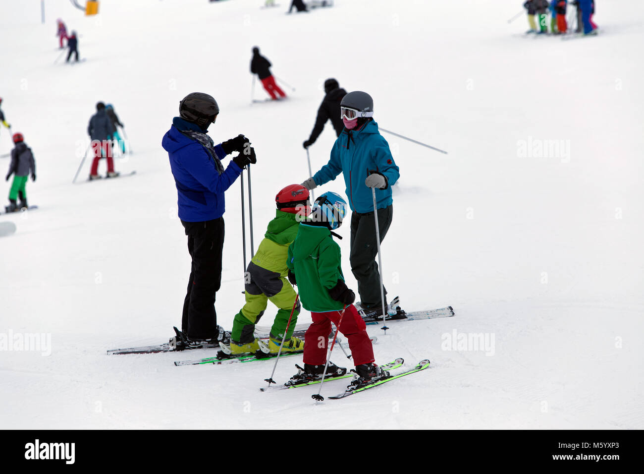 Mother with her children skiing in Flims Switzerland Stock Photo