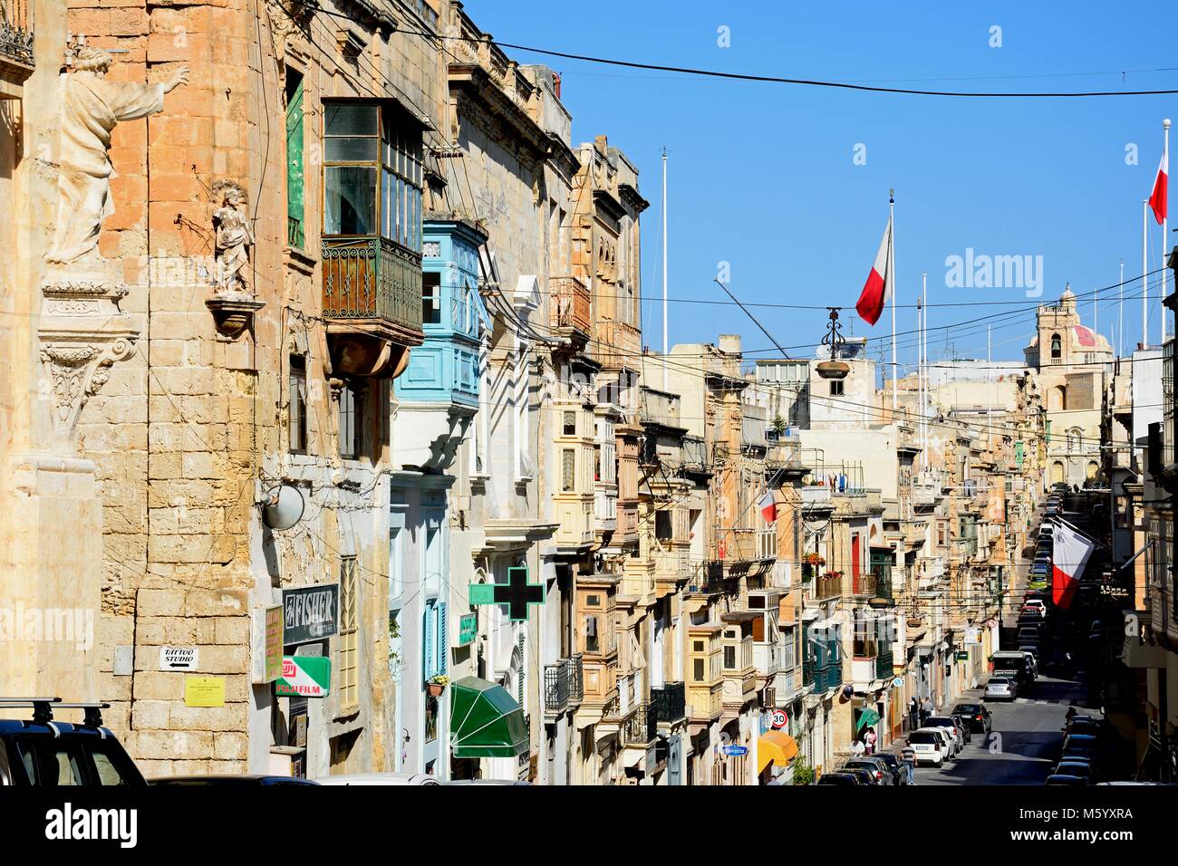 View along the Triq il-Vitorja shopping street, Senglea, Malta, Europe. Stock Photo