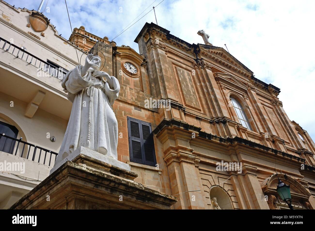 Front view of the Parish church of our lady of sorrows with a statue in the foreground, Bugibba, Malta, Europe. Stock Photo