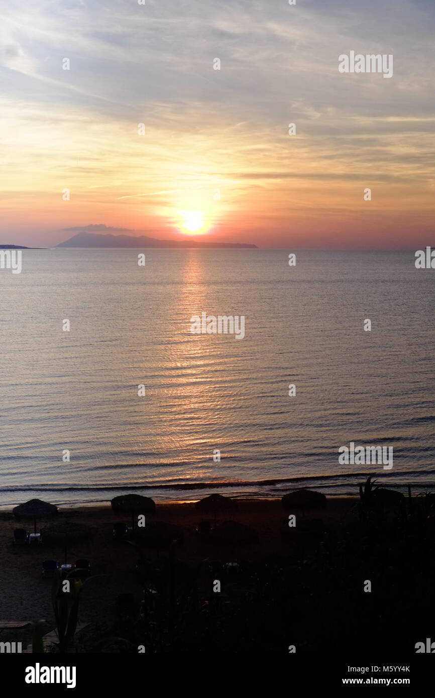 Romantic sunset from a beach bar in Agios Stefanos Corfu Stock Photo