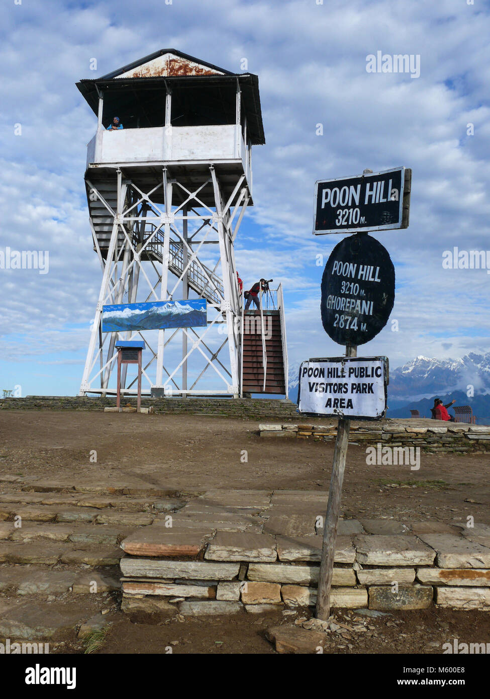 Ghorepani Poon Hill, Nepal, september 27, 2013:  Lookout tower on the one of the most visited Himalayan view points in Nepal, view to snow capped Hima Stock Photo