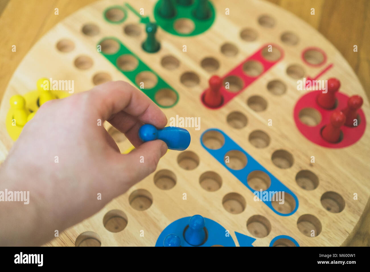 Man playing Ludo board game. Close-up view. Stock Photo