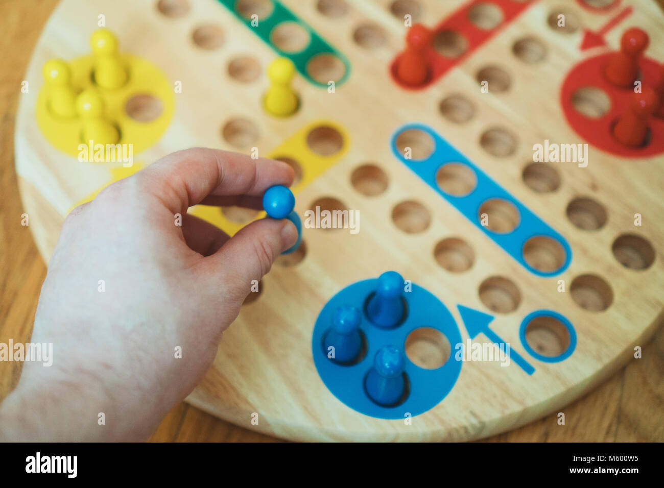 Man playing Ludo board game. Close-up view. Stock Photo