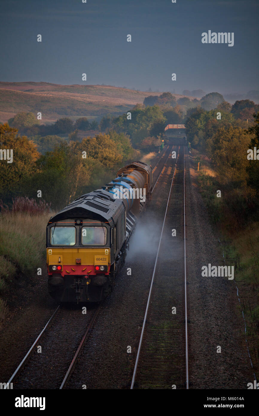 A Network rail Railhead treatment train, washing the leaves from the railhead passes Clapham (Yorkshire)  hauled by Direct rail Services class 66's Stock Photo