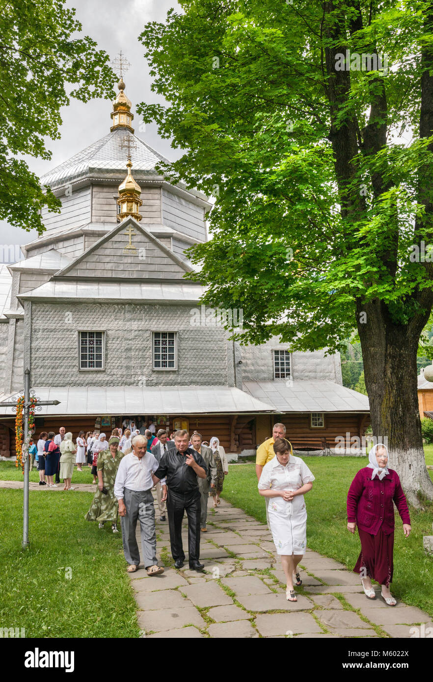 Churchgoers leaving after mass Holy Trinity Greek Catholic Church, in village of Mykulychyn, near town of Yaremche, Carpathian Mountains, Ukraine Stock Photo