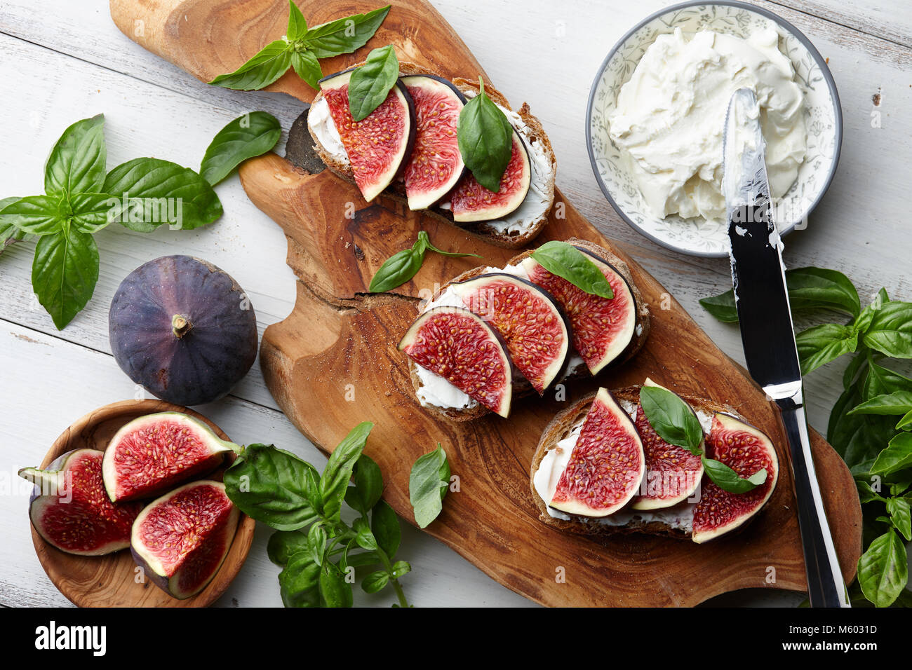 Fresh figs, basil leaves and philadelphia cream cheese bruschetta on