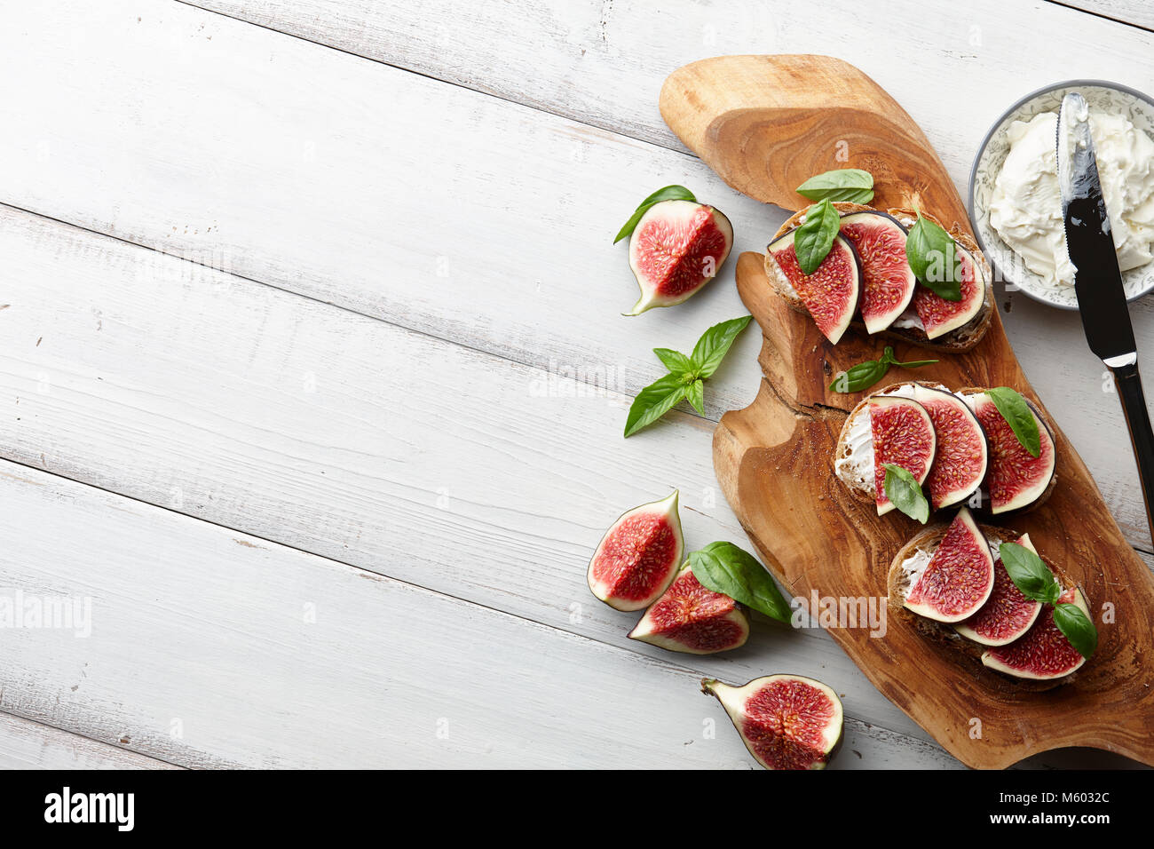 Fresh figs, basil leaves and philadelphia cream cheese bruschetta on