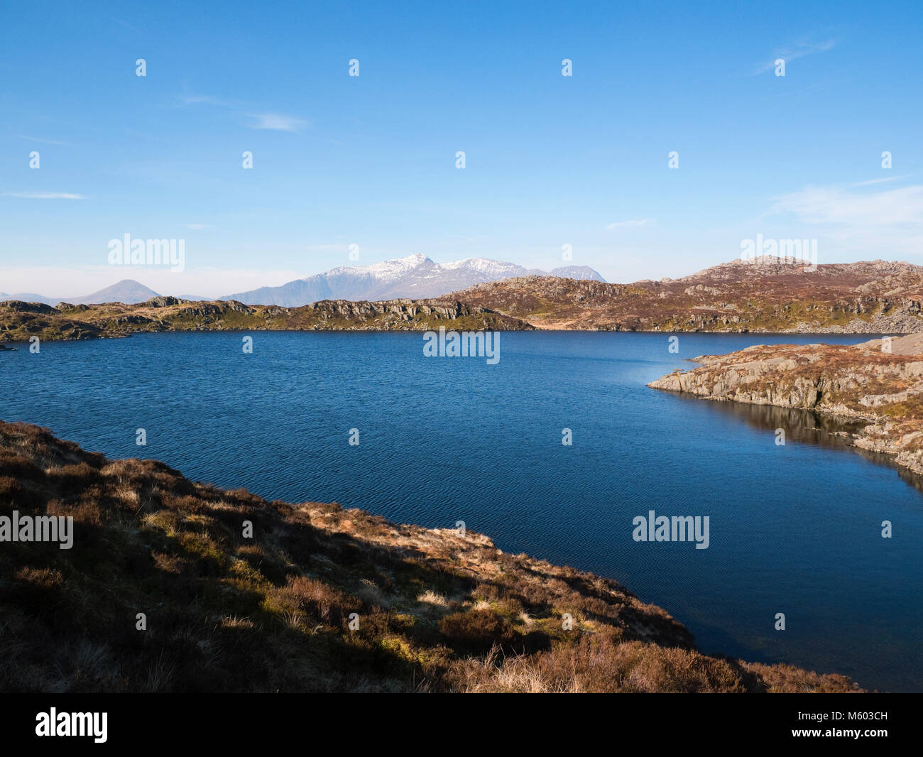 A snow-capped Snowdon group viewed from Llyn Edno in the Moelwyn mountains of Snowdonia. Stock Photo
