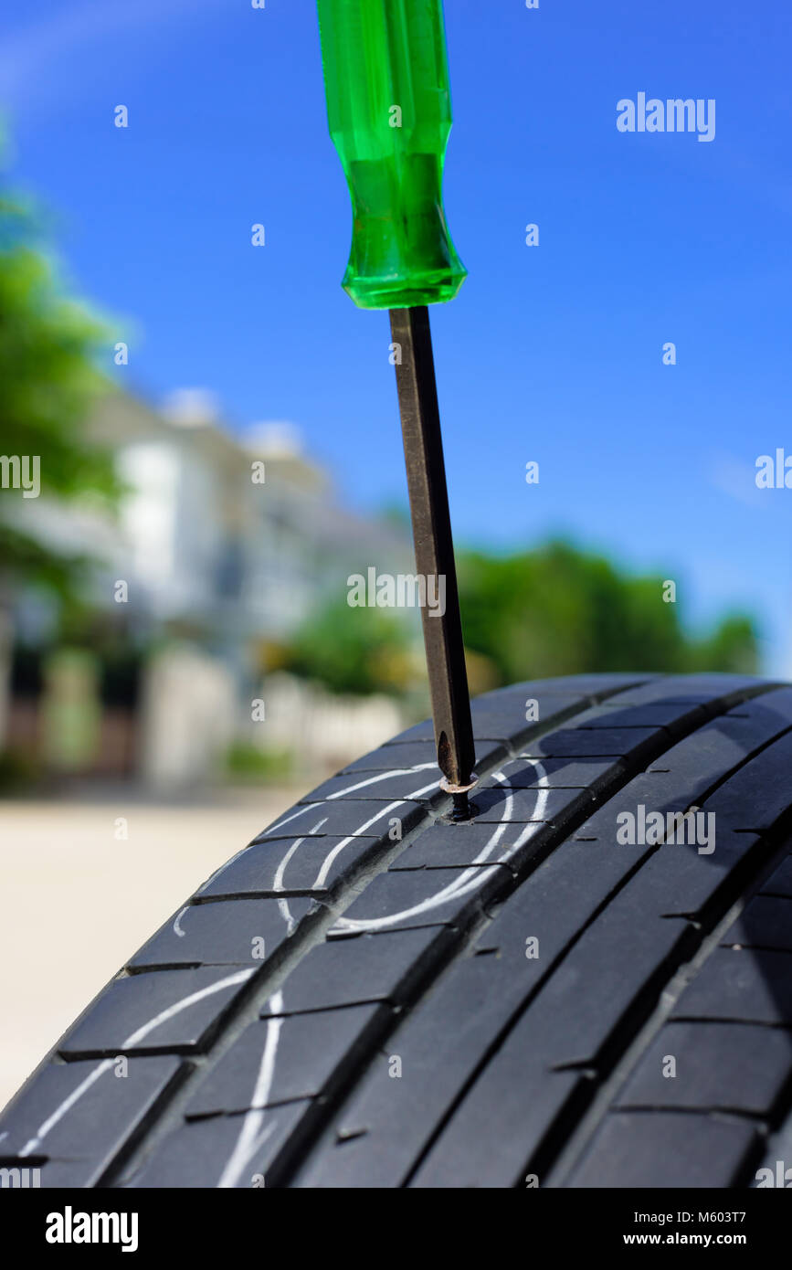unscrew from car tyre, damaged car tyre Stock Photo Alamy