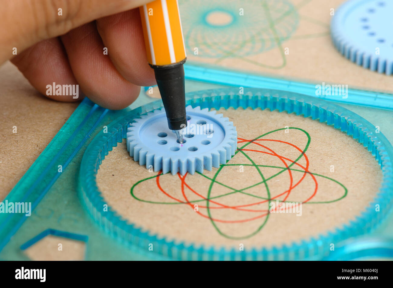 Drawing the spirograph pattern with spirograph kit Stock Photo Alamy