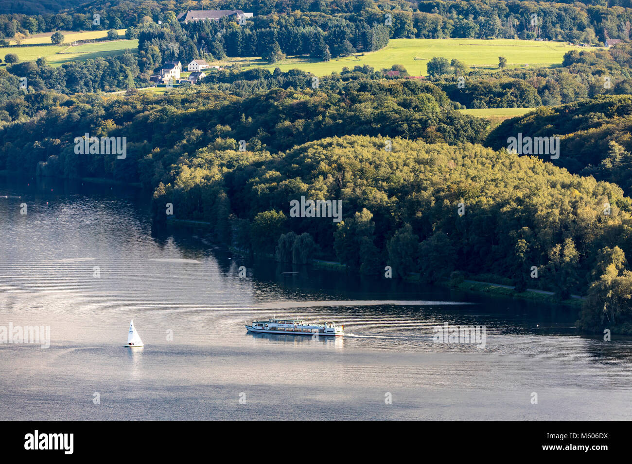 The Baldeneysee Lake, a reservoir of river Ruhr, in Essen, Germany, sailing boats, sightseeing river boat, Stock Photo