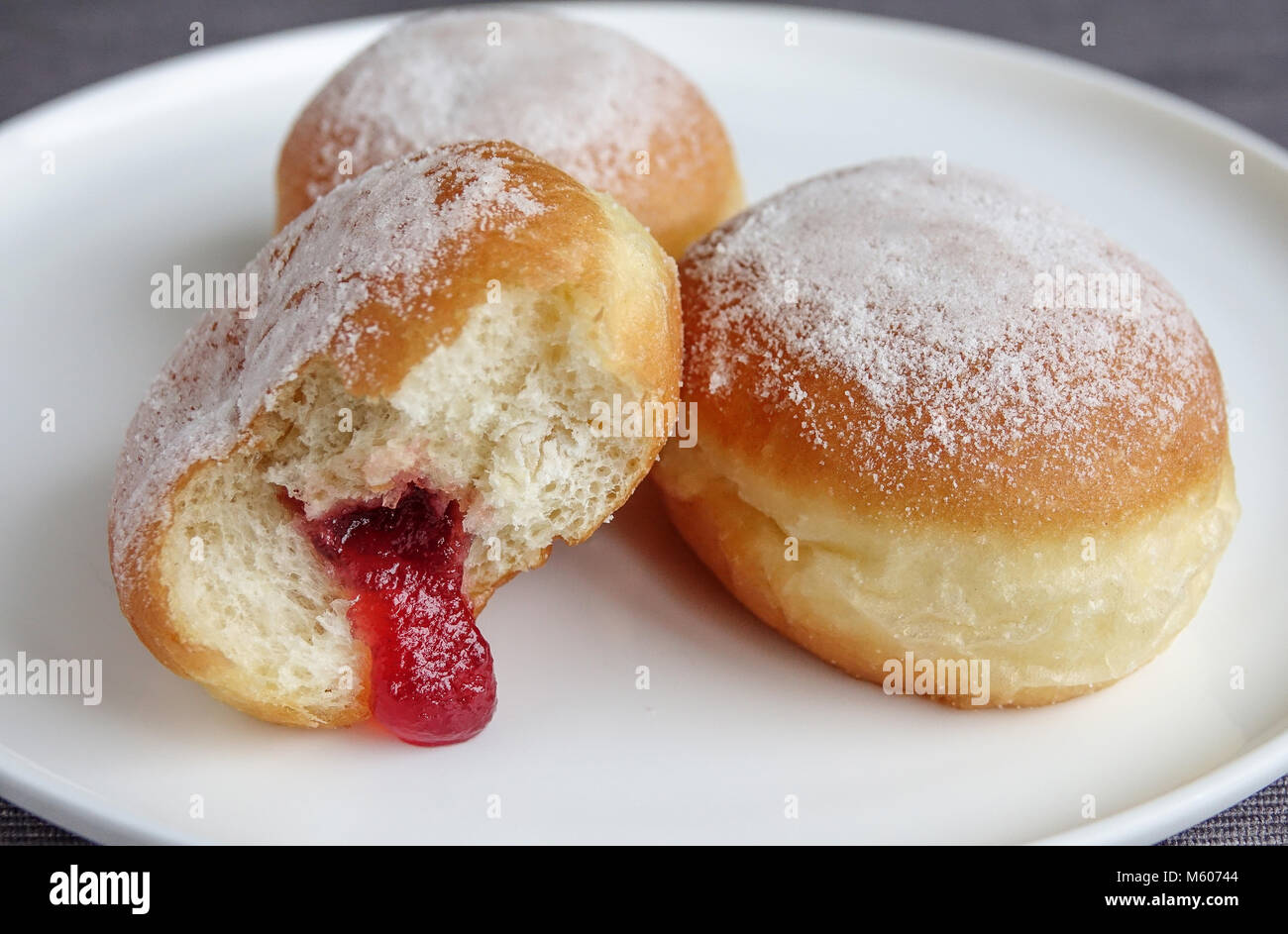 Jam doughnuts on a plate Stock Photo Alamy