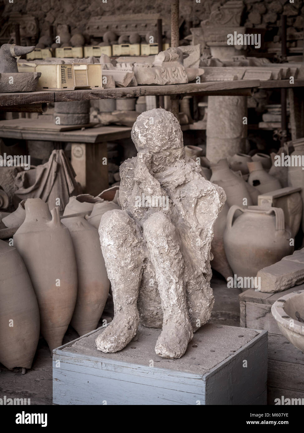 Body cast on display with excavated artefacts at Pompeii, Italy. Stock Photo