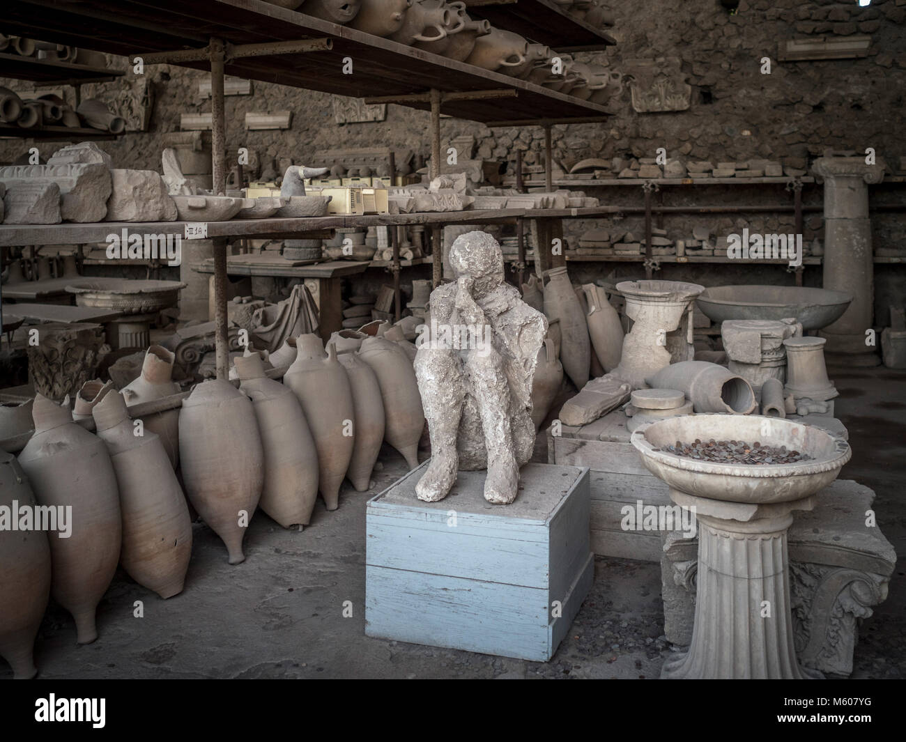 Body cast on display with excavated artefacts at Pompeii, Italy. Stock Photo