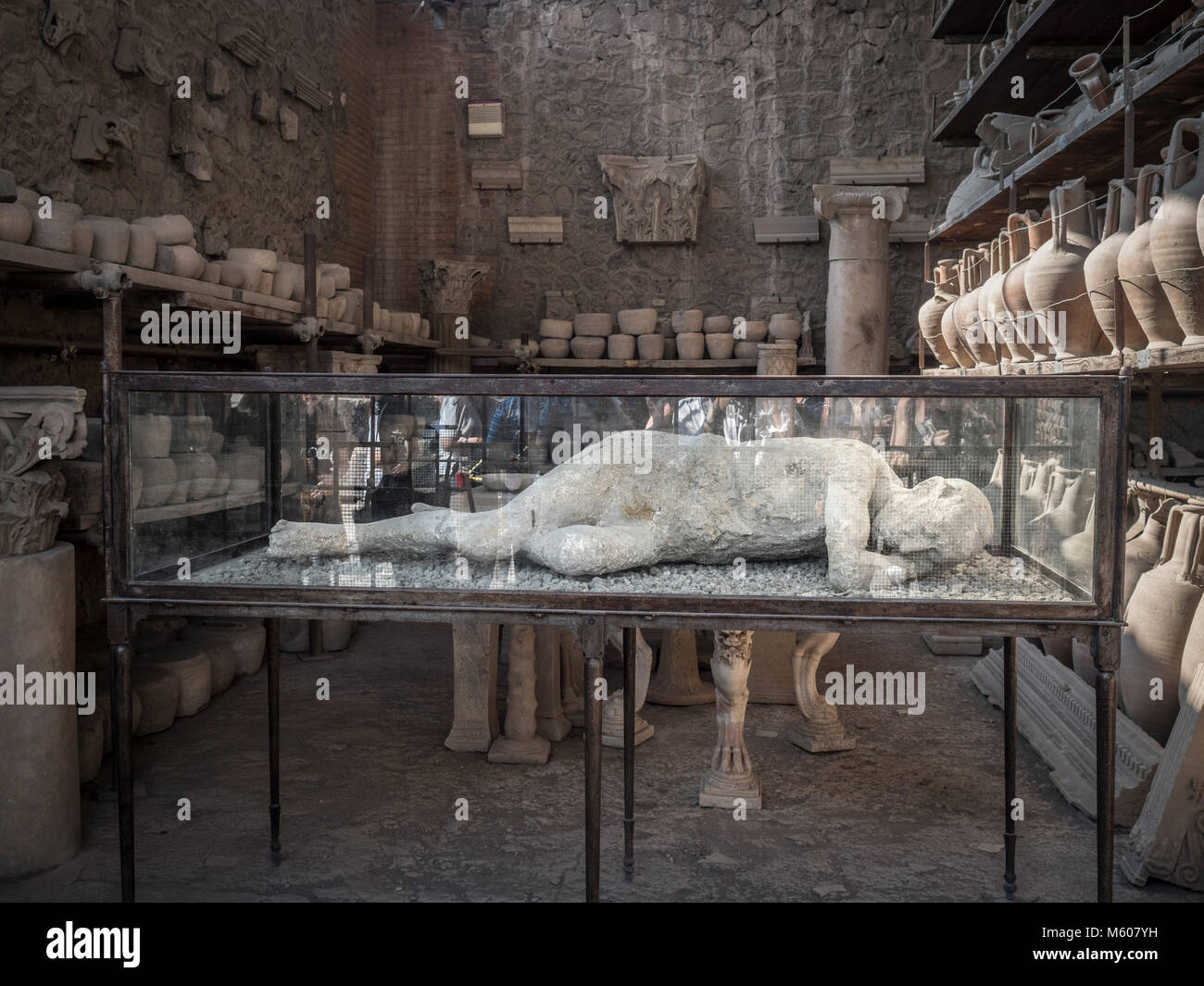 Body cast of a Pompeii victim display in a glass case, along with other excavated artefacts. Pompeii. Italy. Stock Photo