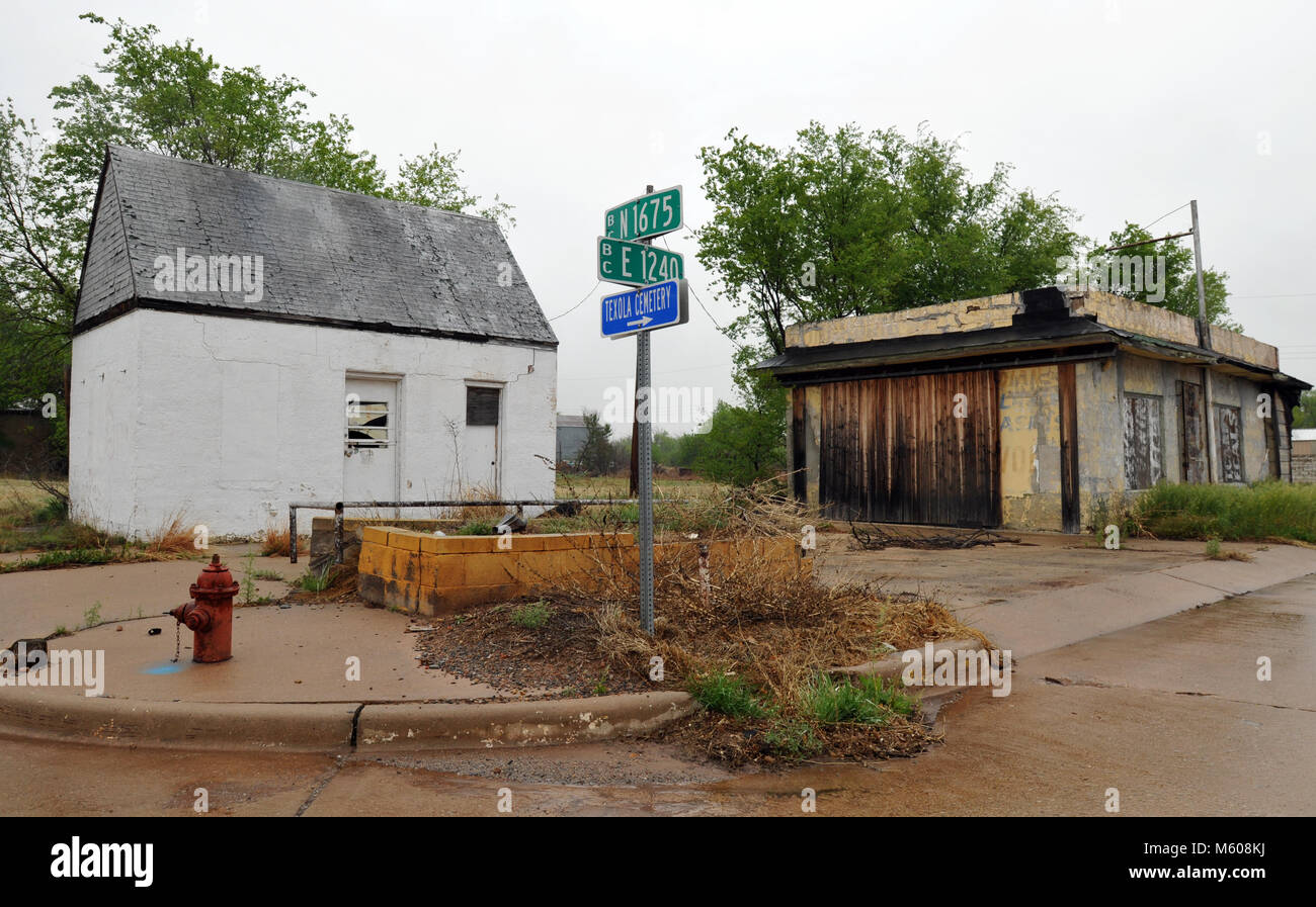 Abandoned buildings stand at a crossroads in the quiet Route 66 town of Texola, Oklahoma, just east of the Texas state line. Stock Photo