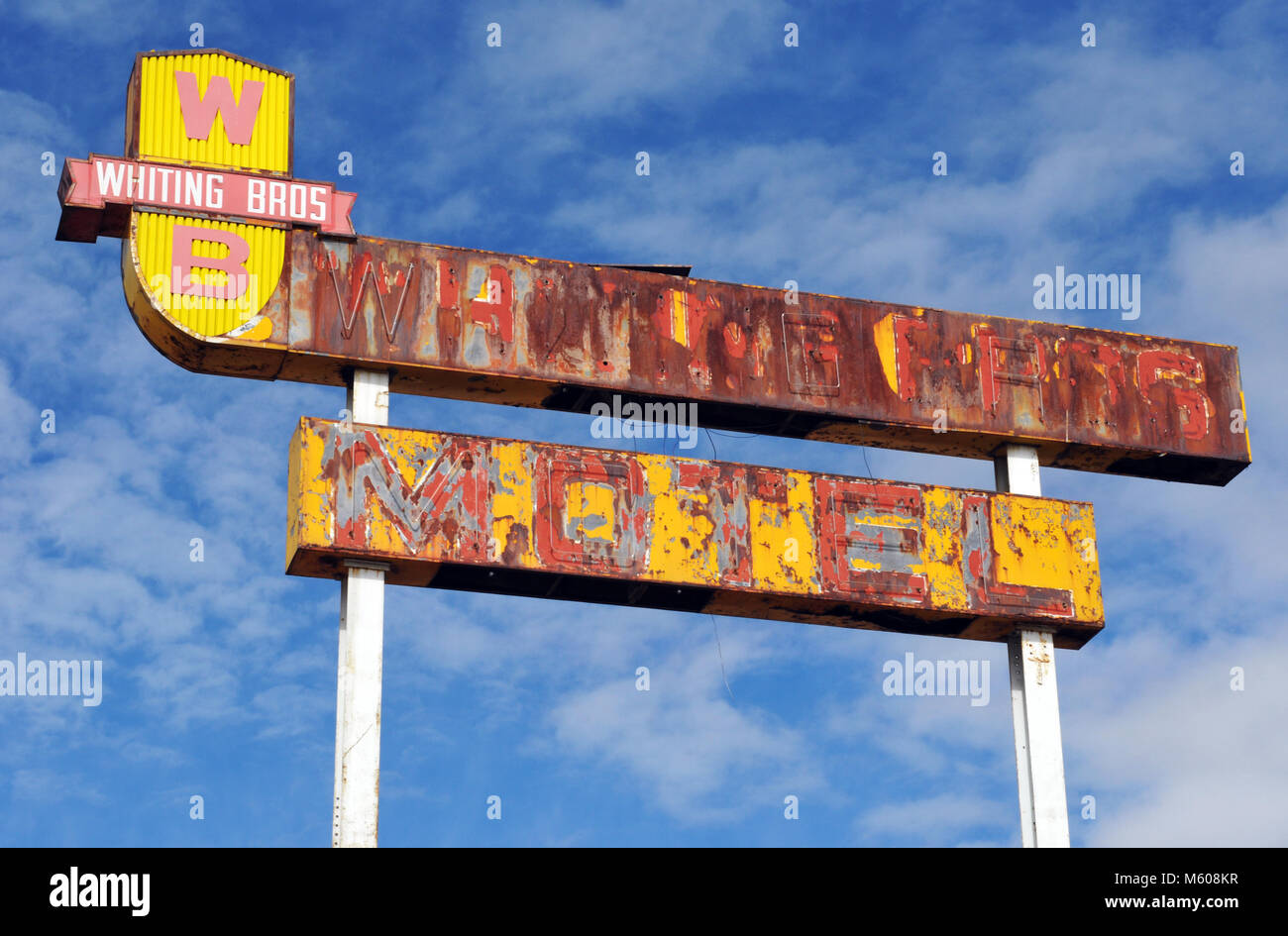 A rusting sign for a former Whiting Brothers motel stands against a blue sky in the old Route 66 community of Continental Divide, New Mexico. Stock Photo