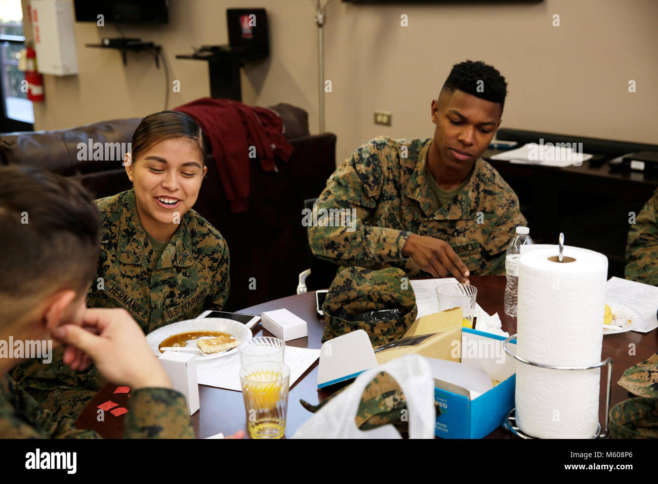 (Left) Private First Class  Jessica Hernandez, secretary Single Marine Program, Marine Corps Logistics Base Barstow, Calif., and Lance Cpl. Louis Guilry, enjoy breakfast and camaraderie at the Annual Assessment Breakfast, held at the Active Duty Marine Recreational Center, Jan. 31. Stock Photo