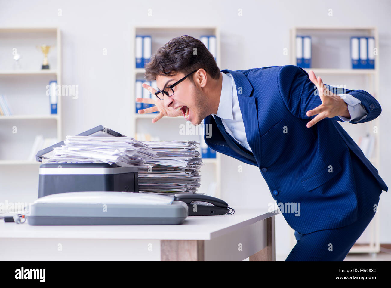 Businessman making copies in copying machine Stock Photo - Alamy