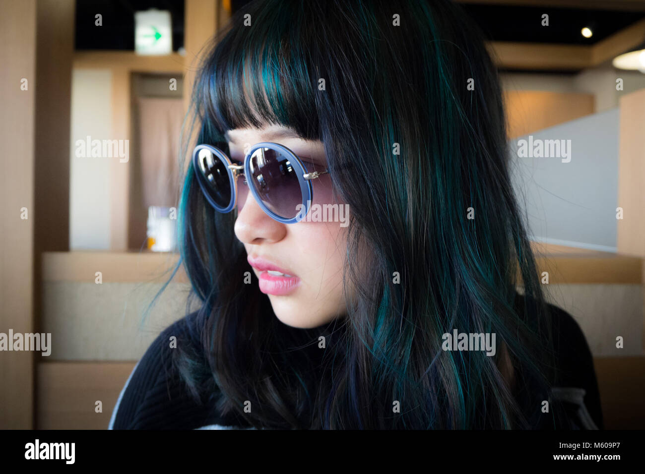 Asian Model With Green And Blue Streaks In Her Hair And Sun