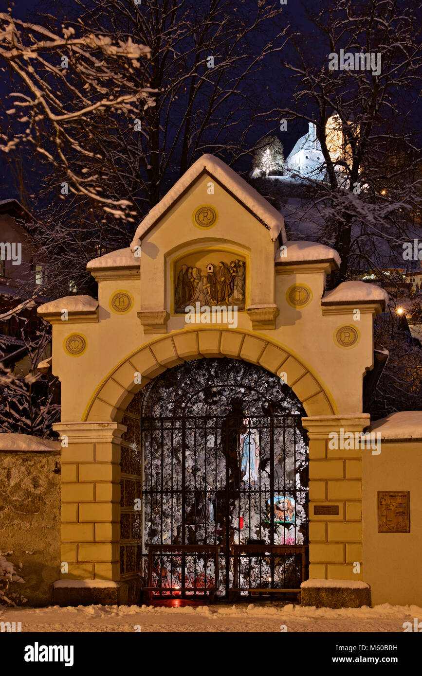 Our Lady of Lourdes Grotto with Freundsberg Castle in background in winter. Schwaz, Tyrol, Austria Stock Photo