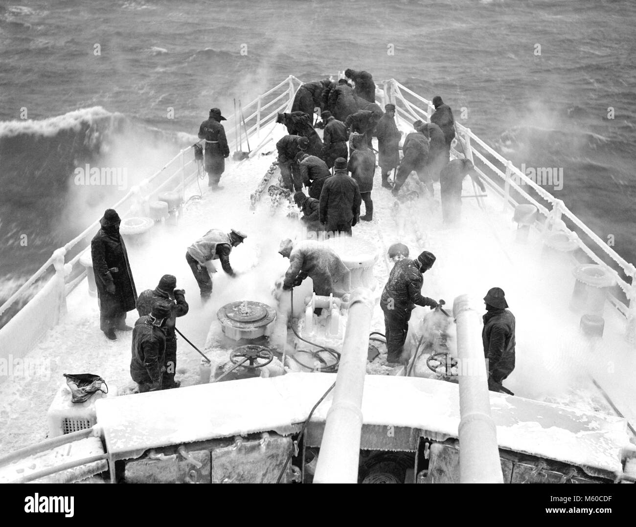 RUSSIAN CONVOY Crew of HMS Scylla using steam hoses to clear decks while on patrol ion the North Atlantic in 1943 Stock Photo