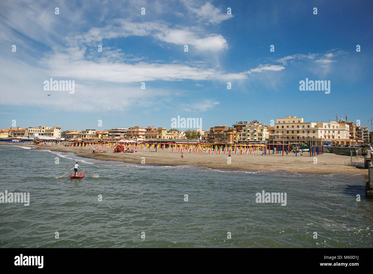 Ostia, Italy. View of the beach and town of Ostia between the Mediterranean sea and sunny sky The town is a seaside resort and ancient port of Rome. Stock Photo