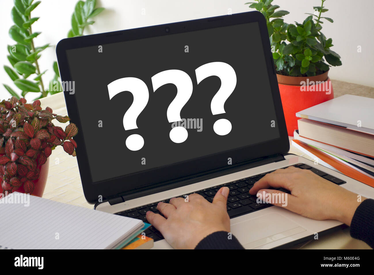 Woman hands on laptop keyboard and question marks on the laptop screen. No experience concept Stock Photo