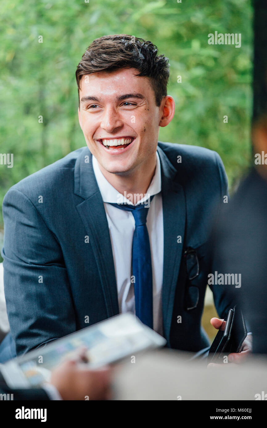 close-up-shot-of-a-business-man-laughing-while-talking-to-someone-in-a