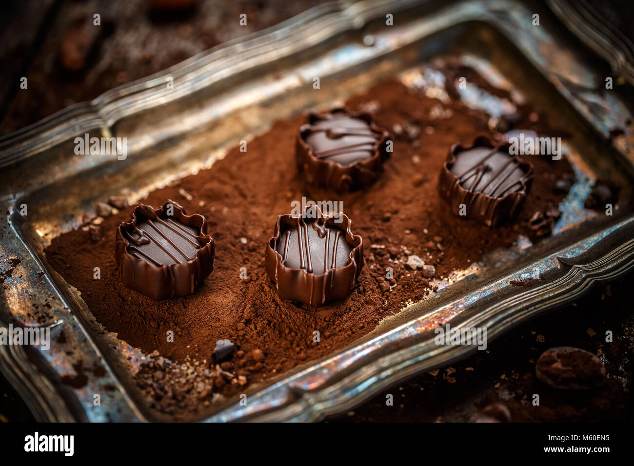 Chocolate mousse pralines in very thin-sliced dark chocolate Stock Photo