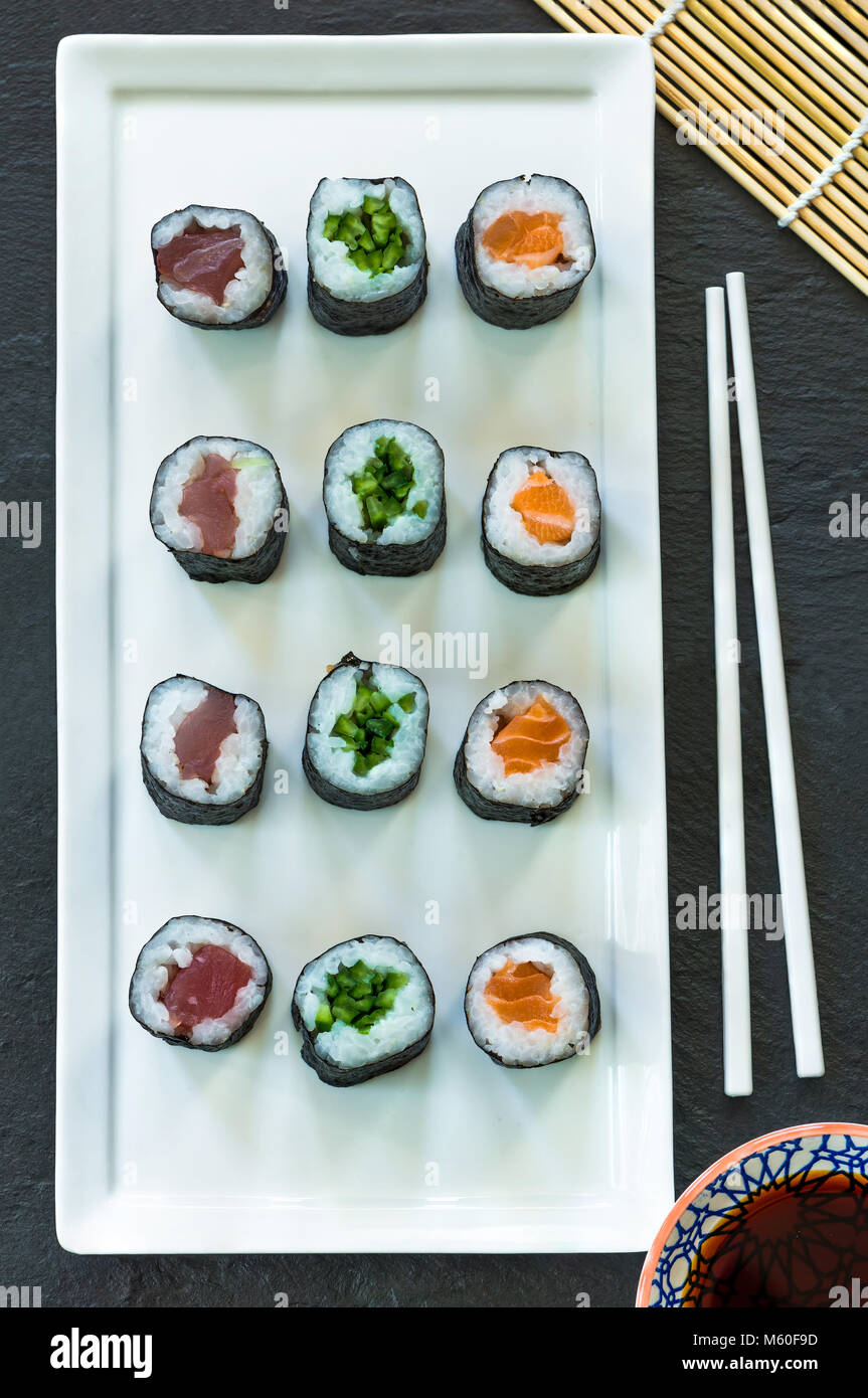 A selection of sushi rolls with salmon, tuna, cucumber and soy sauce dip top view Stock Photo