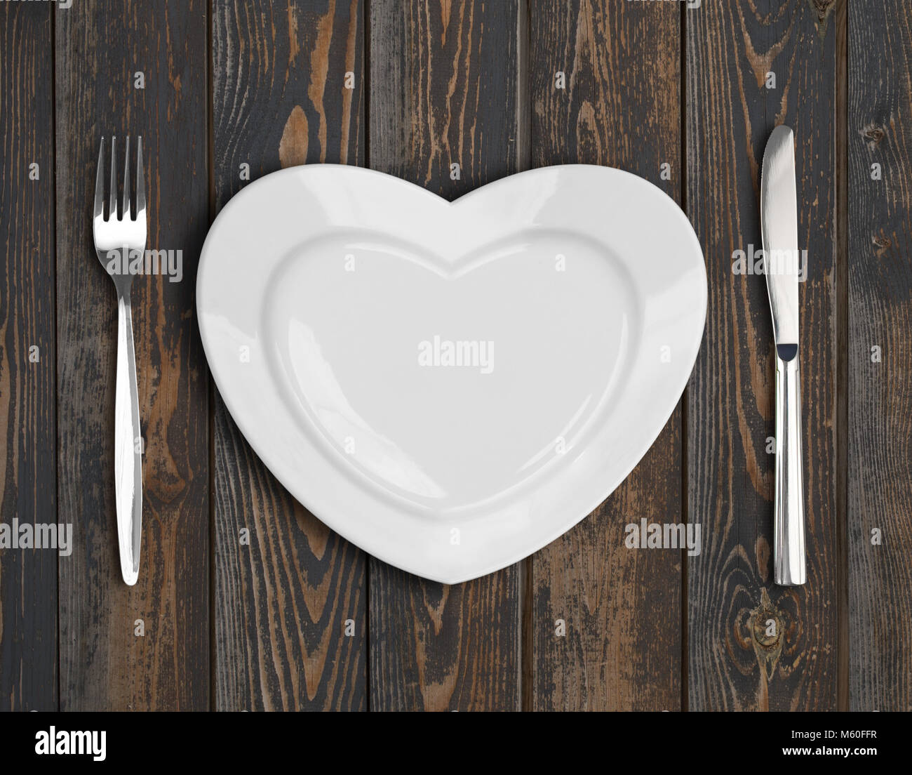 empty heart plate top view on wood table Stock Photo