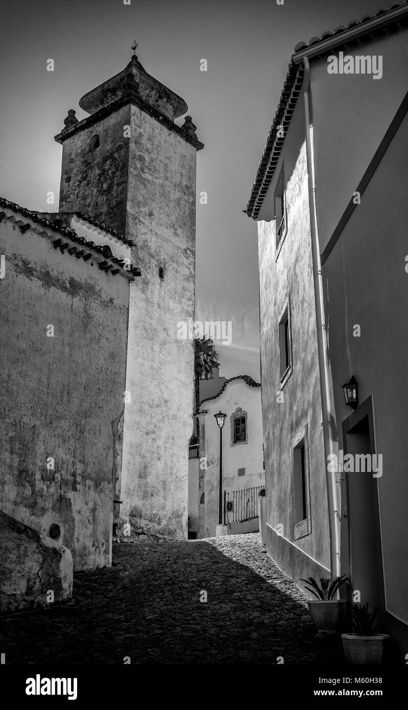 Narrow alley, church and street light, Marvao, Alentejo, Portugal Stock Photo