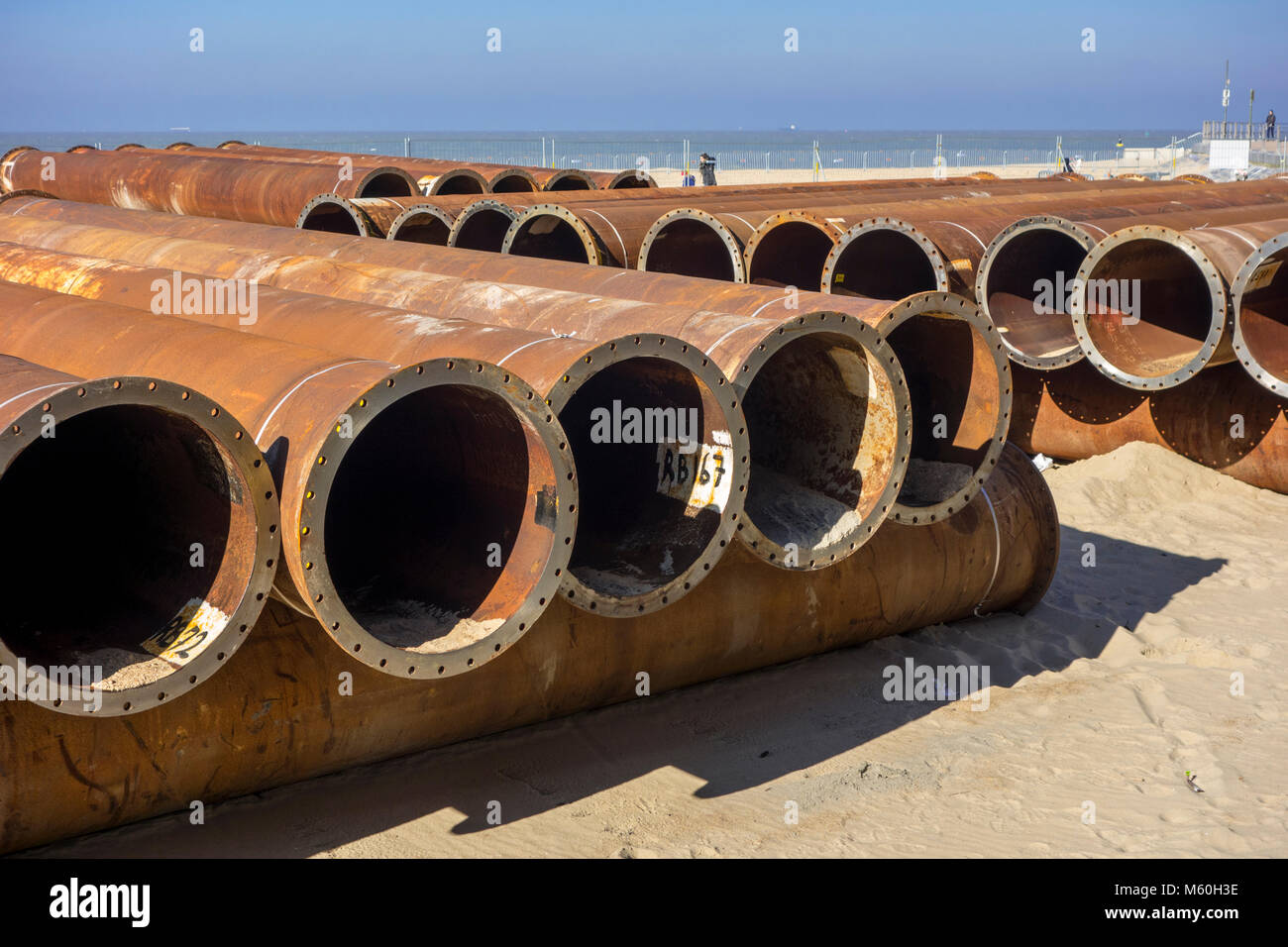 Pipeline tubes for sand replenishment / beach nourishment to make wider beaches to reduce storm damage to coastal structures Stock Photo