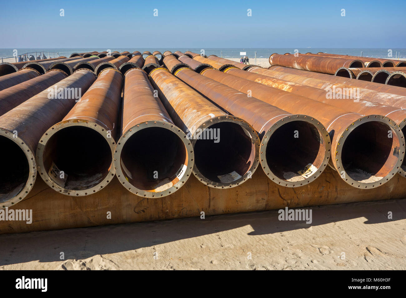 Pipeline tubes for sand replenishment / beach nourishment to make wider beaches to reduce storm damage to coastal structures Stock Photo