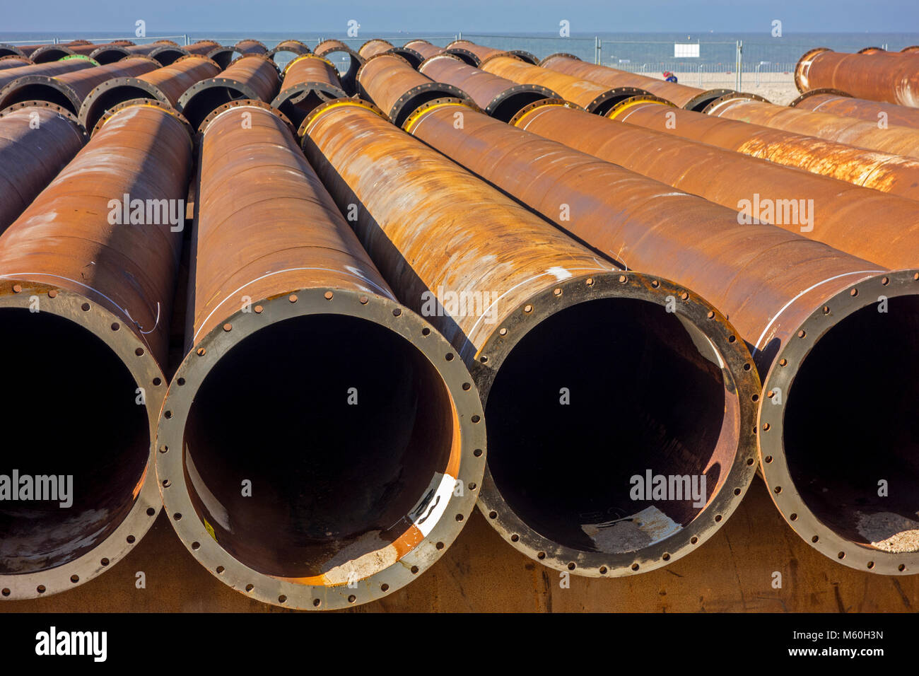 Pipeline tubes for sand replenishment / beach nourishment to make wider beaches to reduce storm damage to coastal structures Stock Photo