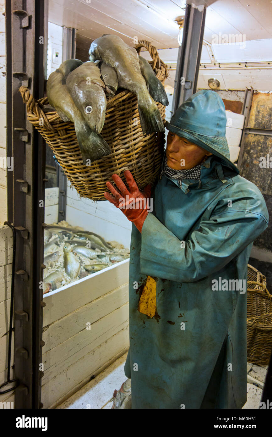 Fisherman wearing Sou'wester in the fish hold of the last Iceland trawler Amandine, renovated fishing boat now serves as museum in Ostend, Belgium Stock Photo