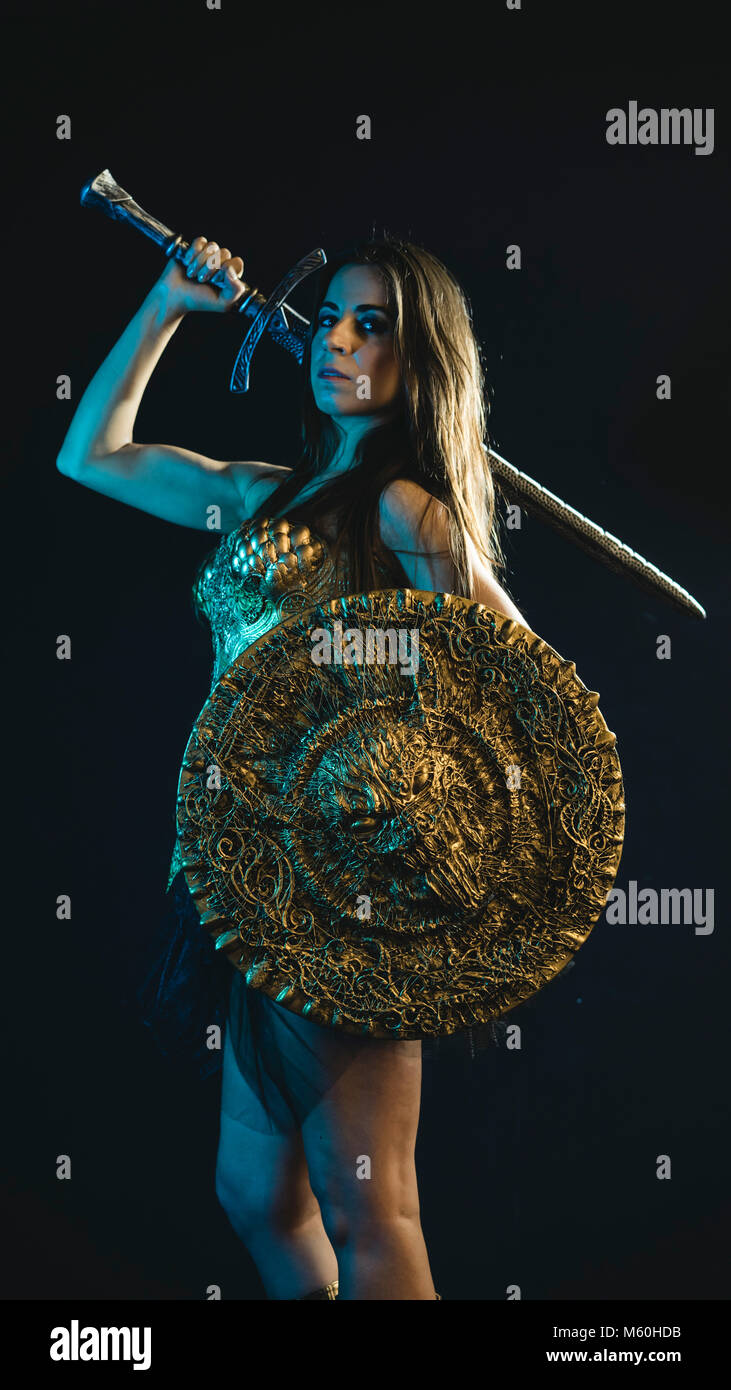 valkyrie warrior, woman with golden armor iron coat and big warrior sword Stock Photo