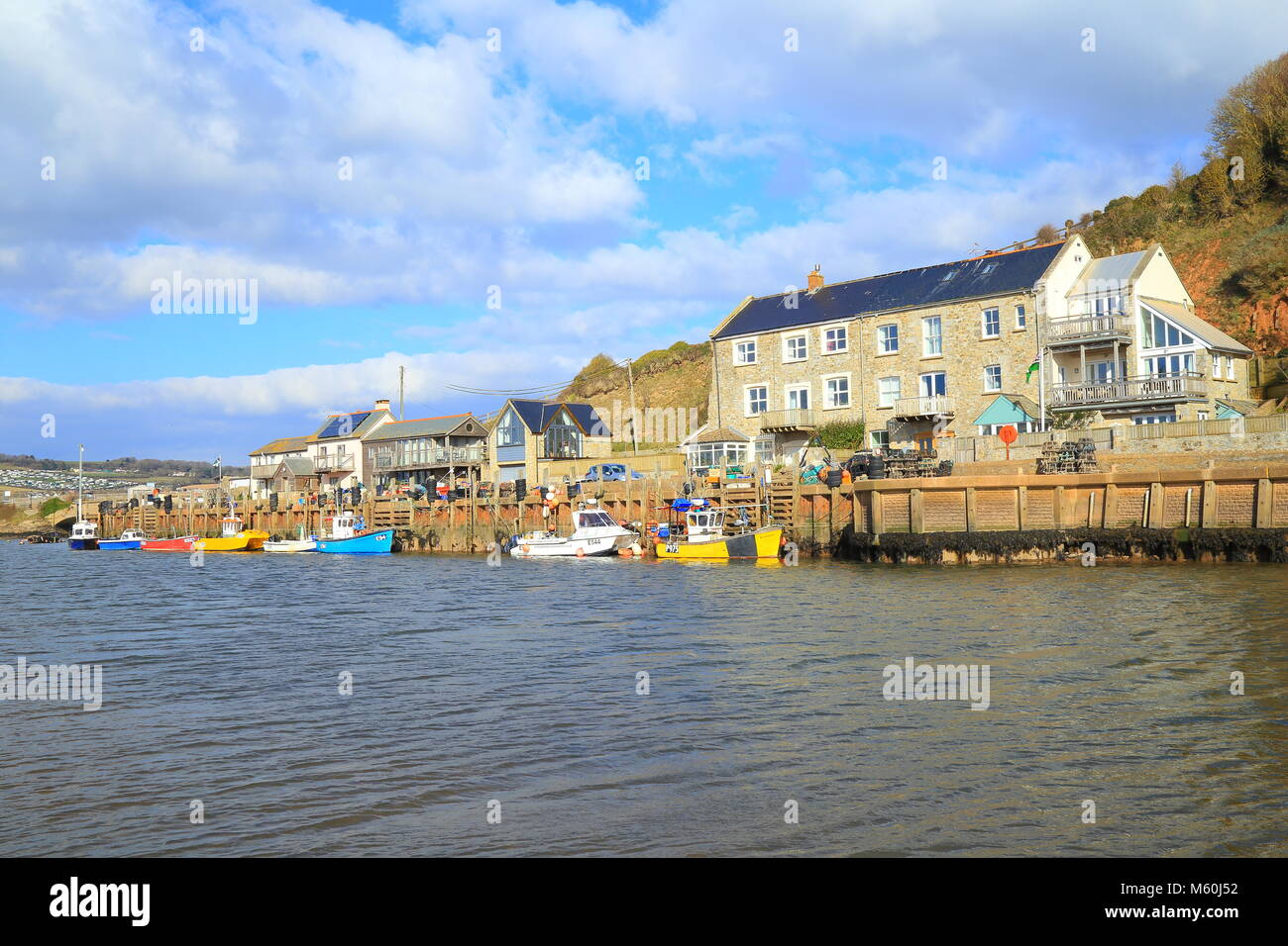 Colourful boats moored at Axmouth Harbour on the river Axe Estuary near town of Seaton in East Devon Stock Photo