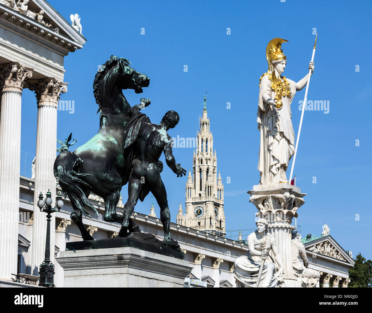 The horse tamer, Pallas Athena sculptures and Rathaus steeple, Austrian Parliament Building, Ringstrasse, Vienna, Austria. Stock Photo