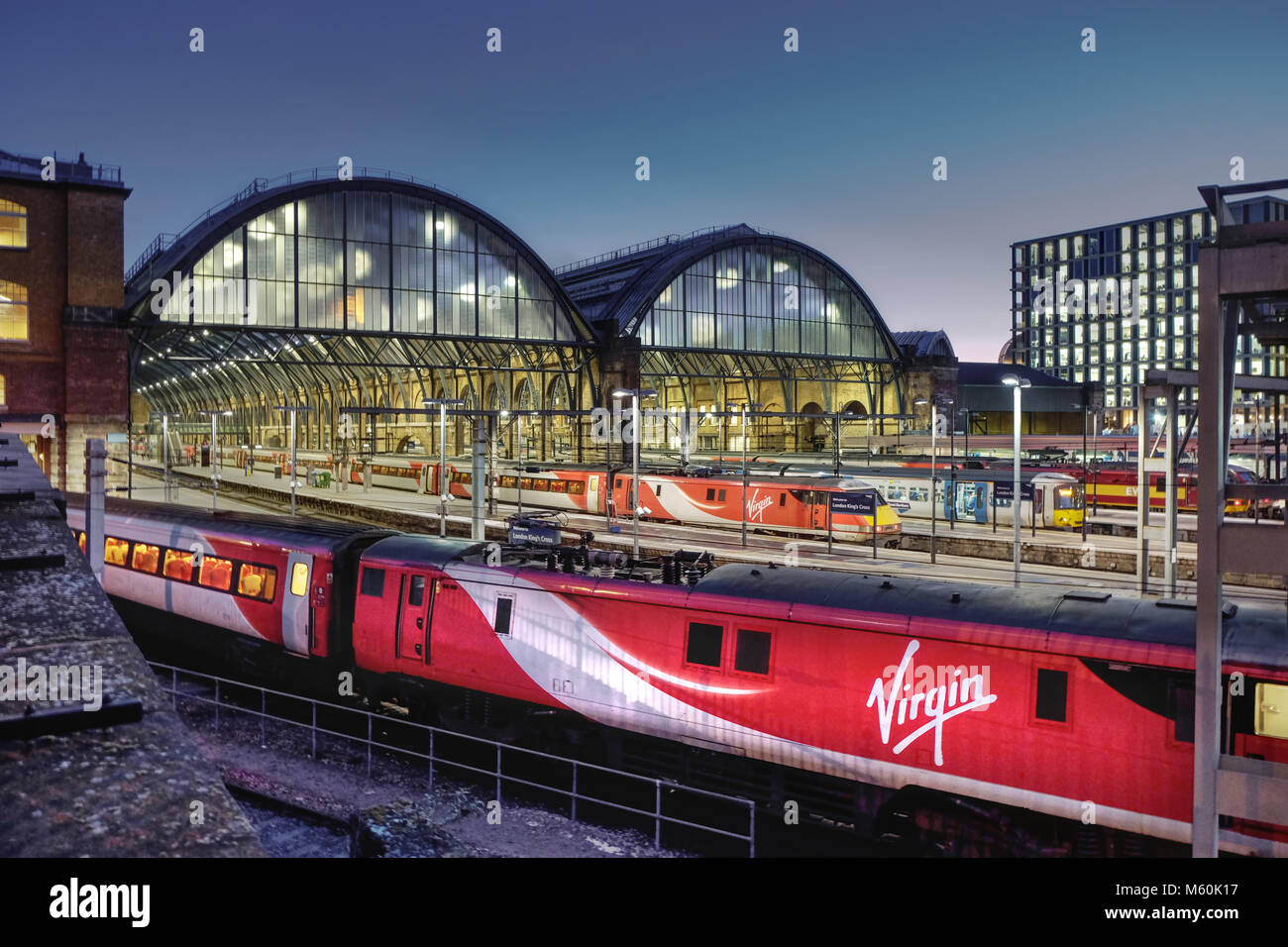 Virgin trains at King's Cross station, London at night Stock Photo