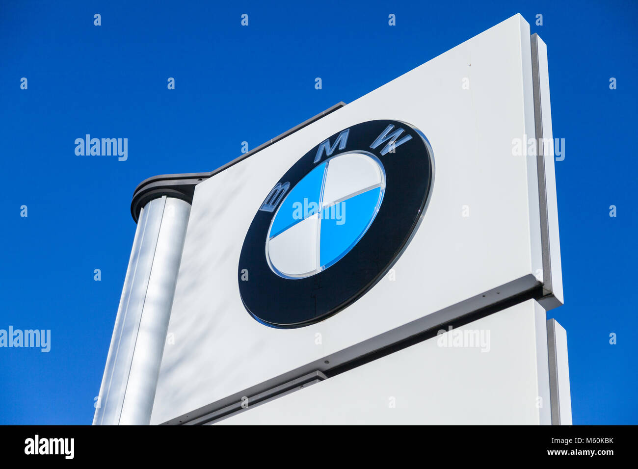 FUERTH / GERMANY - FEBRUARY 25, 2018: BMW logo near a car dealer. BMW is a German multinational company which currently produces automobiles and motor Stock Photo