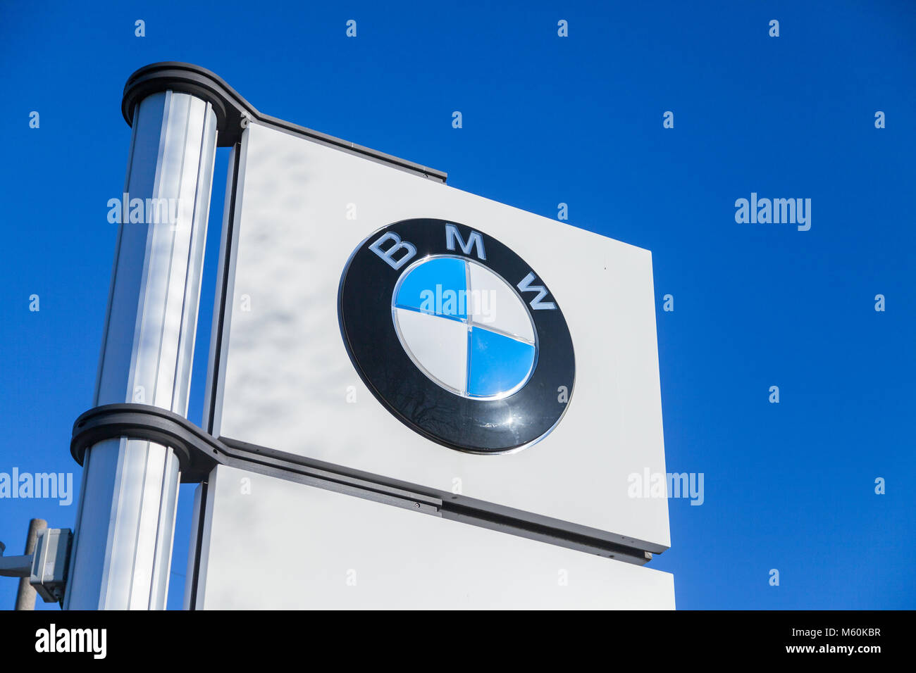 FUERTH / GERMANY - FEBRUARY 25, 2018: BMW logo near a car dealer. BMW is a German multinational company which currently produces automobiles and motor Stock Photo
