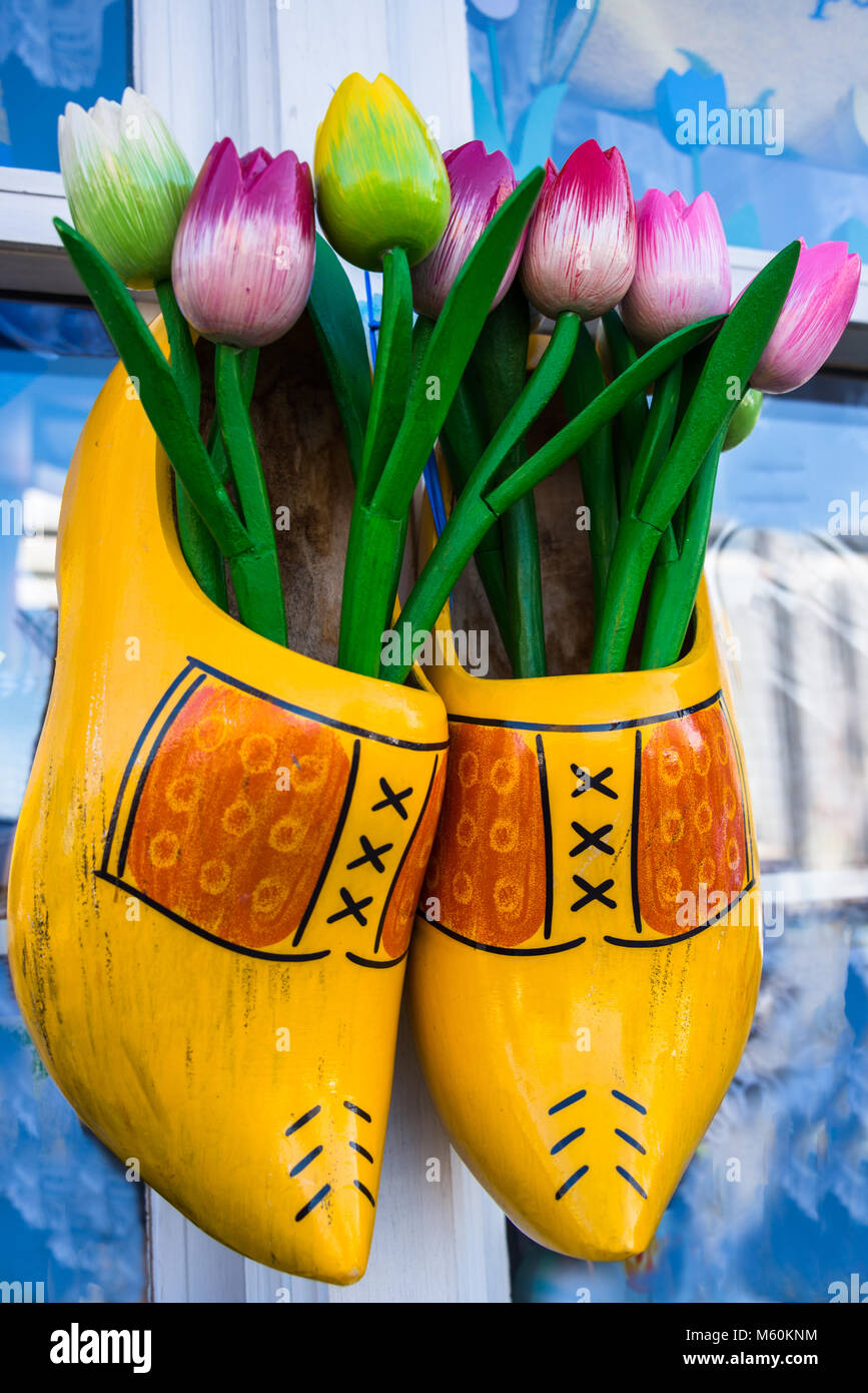 Wooden Clogs and Tulips Hanging on a Wall.  Close up. Stock Photo