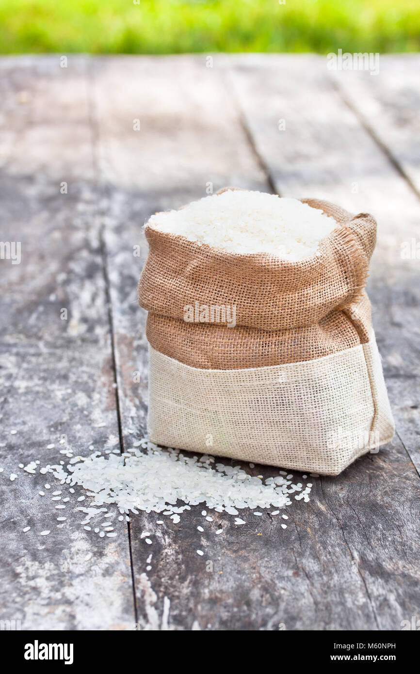 rice bag on the brown table with green grass Stock Photo - Alamy
